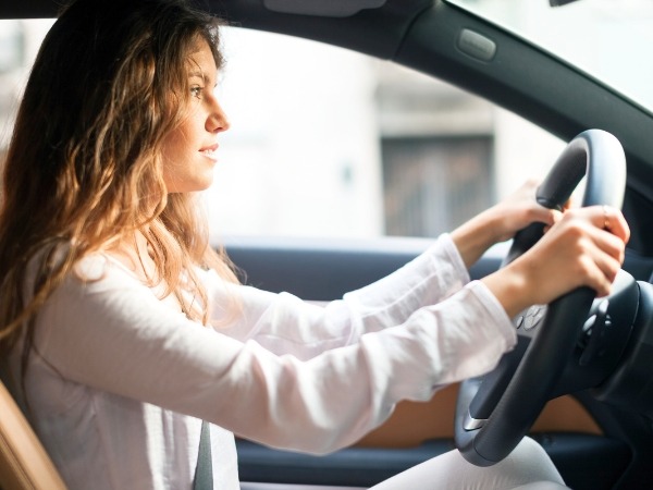 Woman Driving a White Car