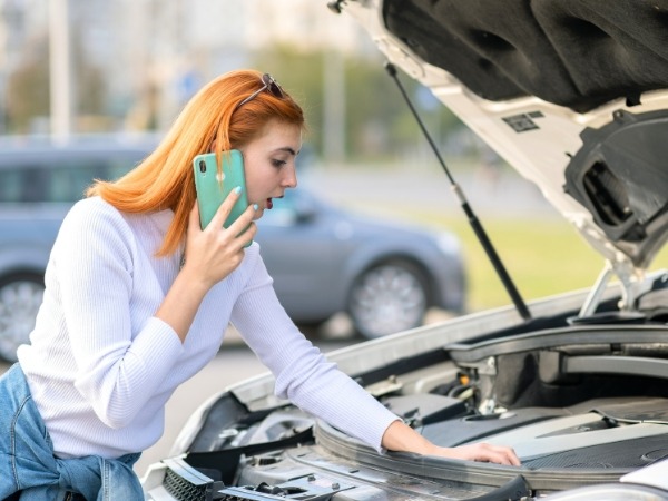 Woman Checking a Car's Engine