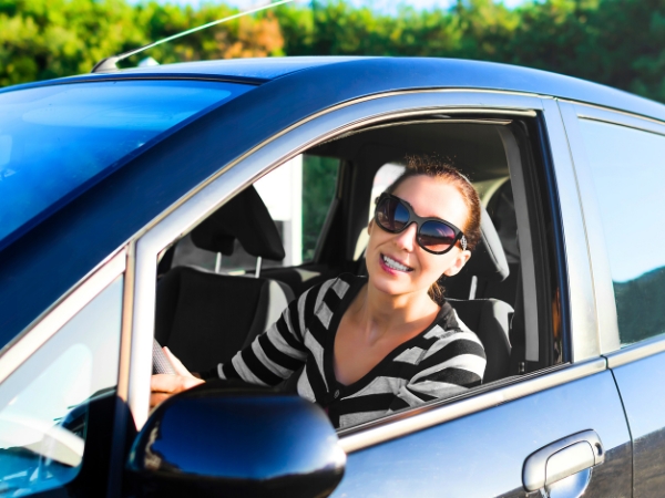 Woman Driving a Car in Nature