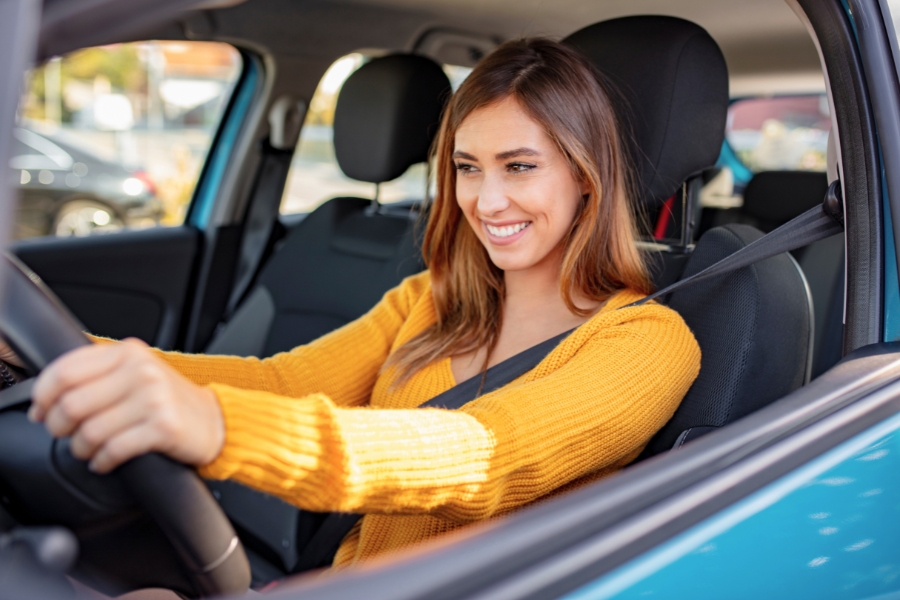 Woman Driving a Blue Car