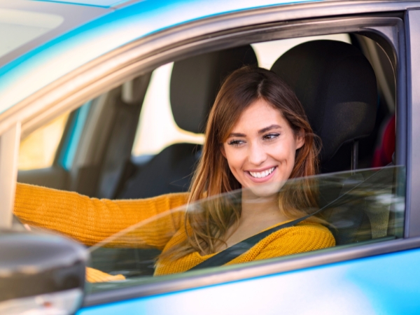 Woman Driving a Blue Car