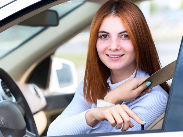Woman Driving a White Car