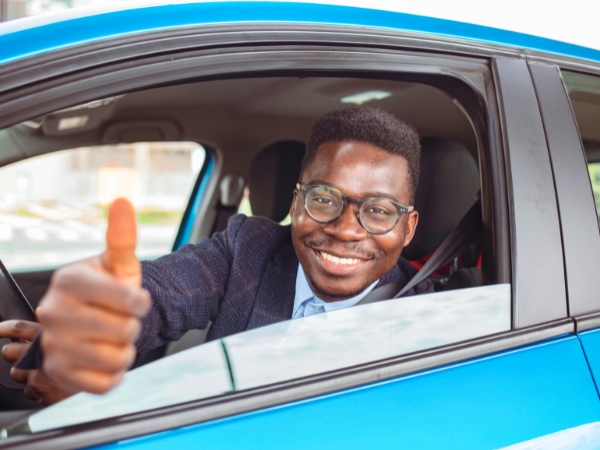 Man Driving a Blue Car