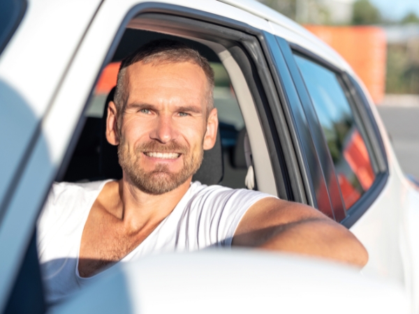 Man Driving a White Car