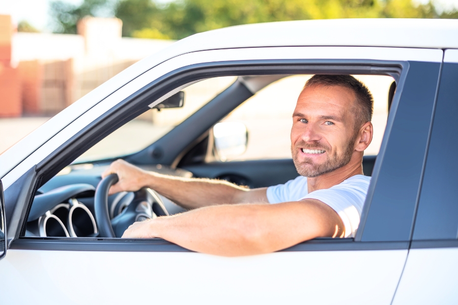 Man Driving a White Car