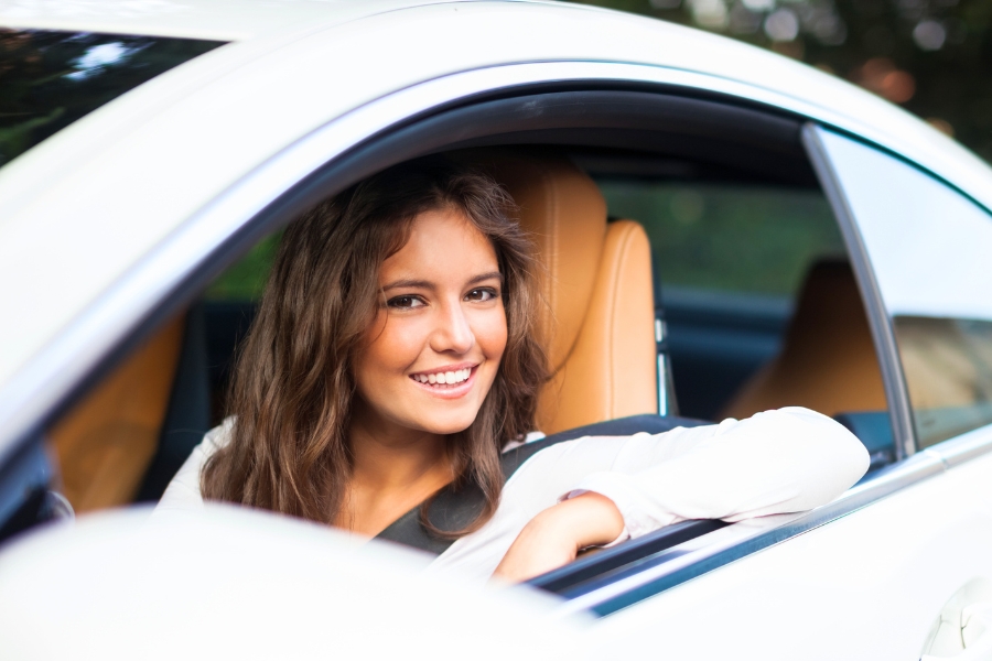 Woman Driving a White Car